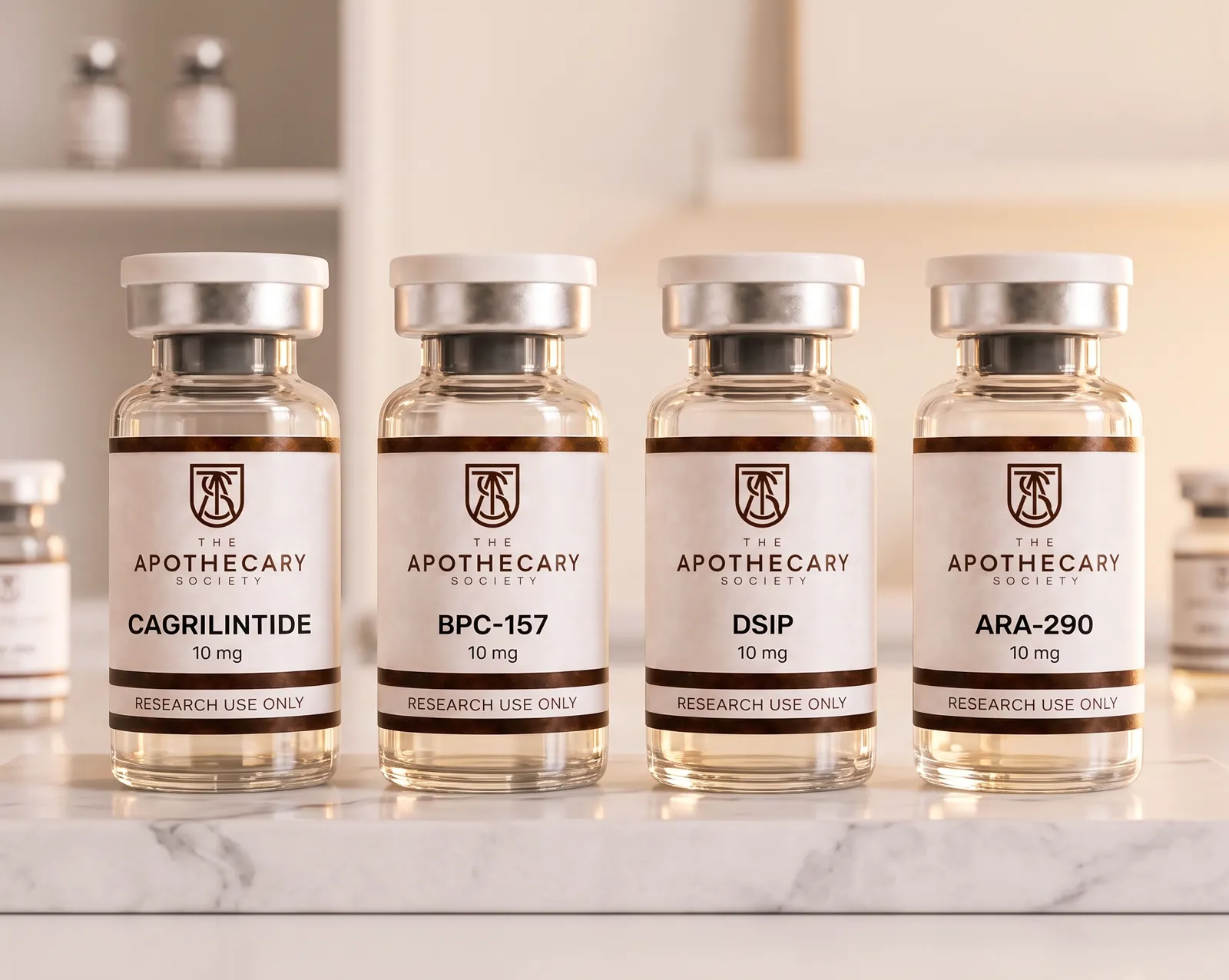 Four Apothecary Society vials — Cagrilintide, BPC-157, DSIP and ARA-290 — on a marble slab